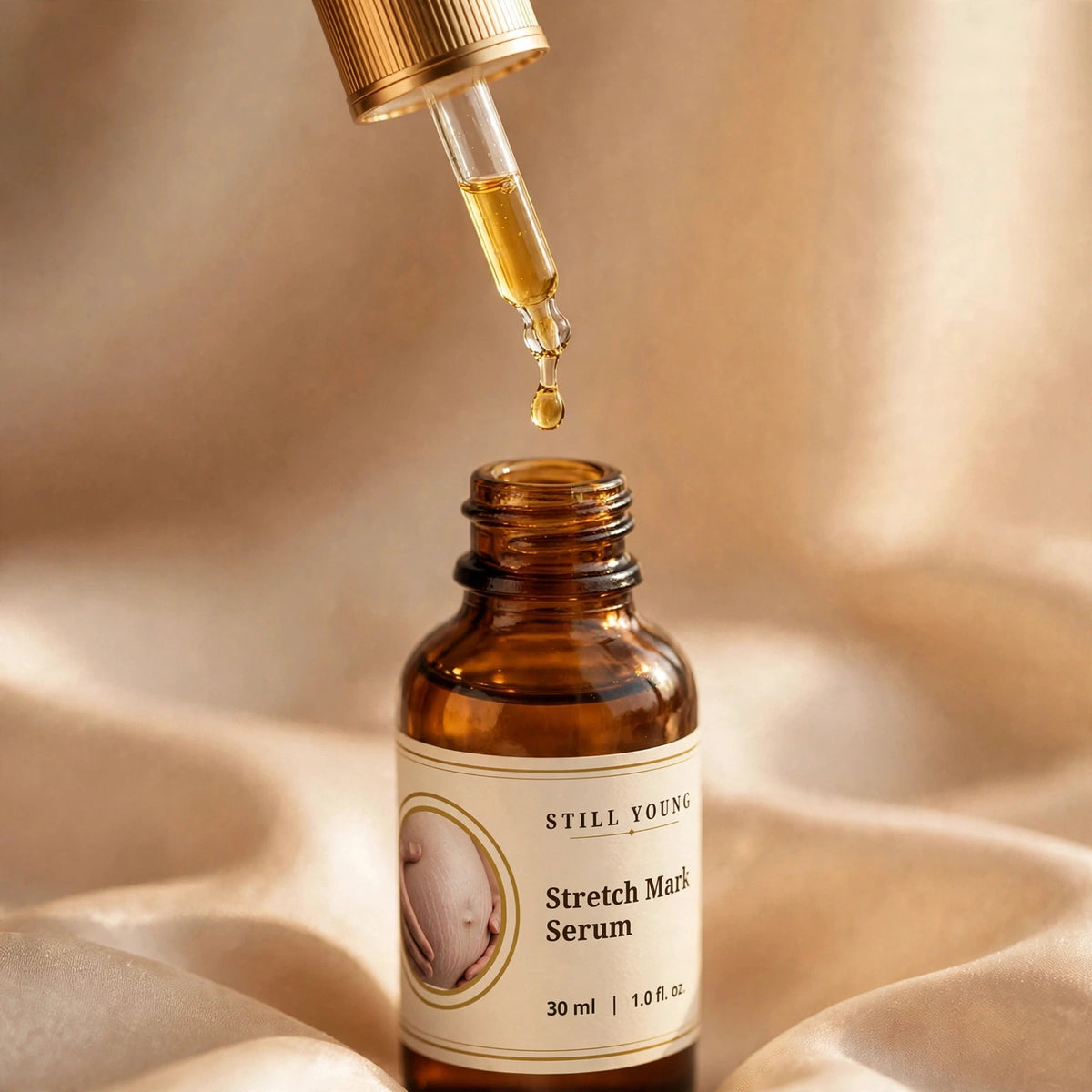 Still Young Stretch Mark Serum golden oil drop falling from dropper close-up